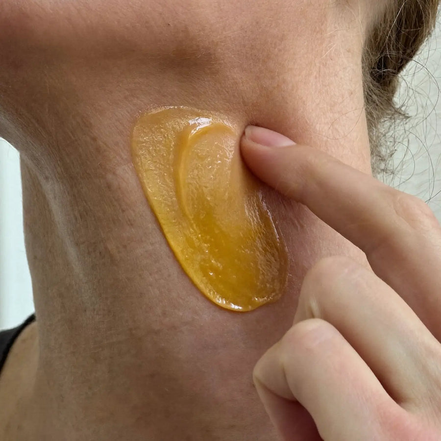 Cream being massaged upward onto the neck
